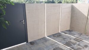 a grey door and concrete wall
